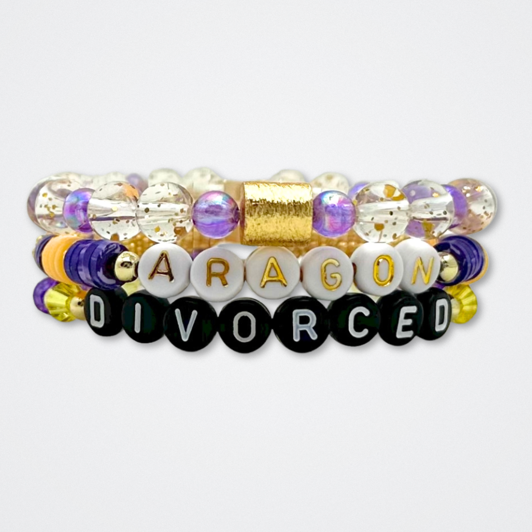 Broadway Stacks QUEEN collection. Stretch bracelets included in Stack. Gold, yellow, green, white, red, pink and blue colored beads. Letter beads that spell each queen. Also Herstory collection. Broadway Stacks gold star logo bead to remind you that You Shine. SIX the Musical fans.