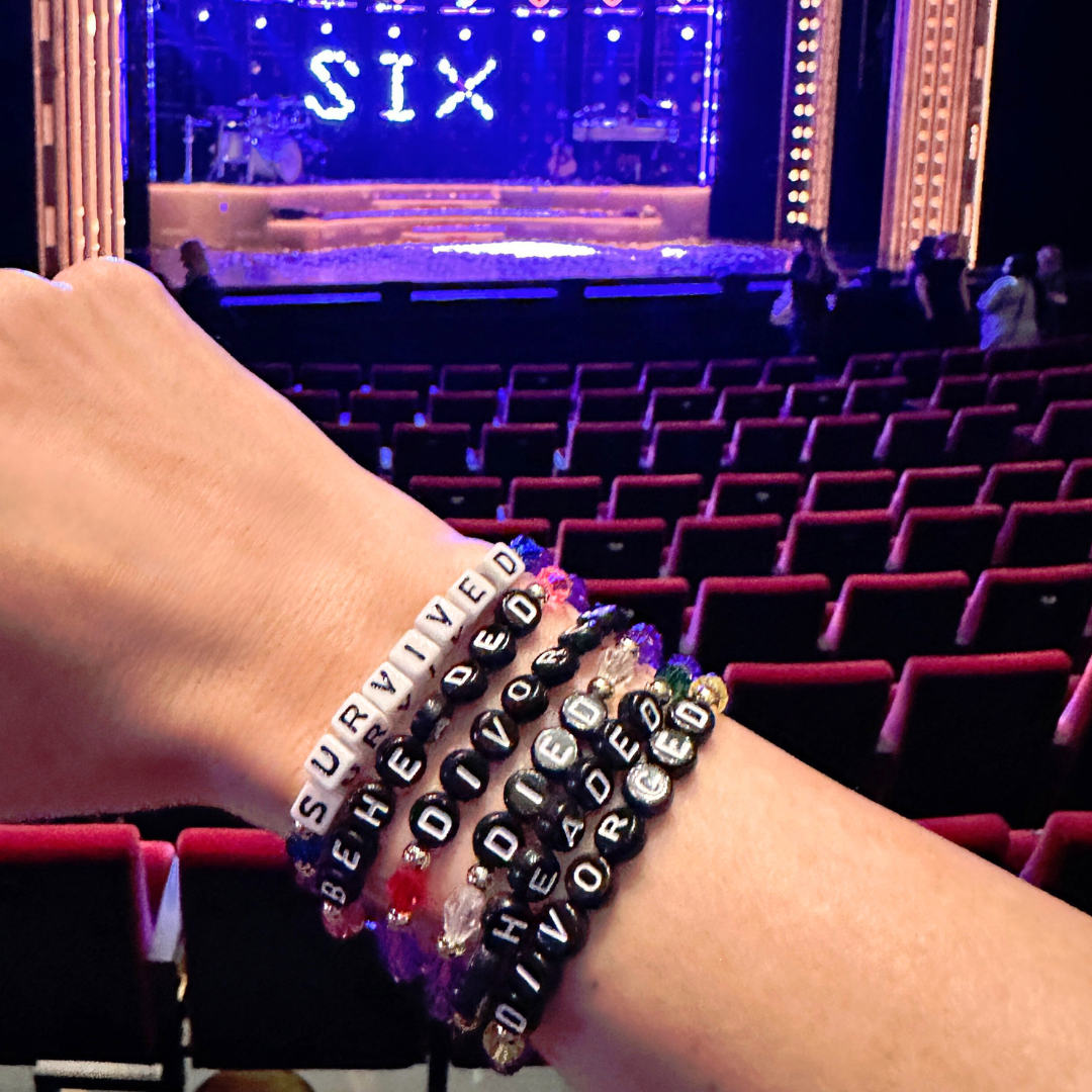 Broadway Stacks QUEEN collection. Stretch bracelets included in Stack. Gold, yellow, green, white, red, pink and blue colored beads. Letter beads that spell each queen. Also Herstory collection. Broadway Stacks gold star logo bead to remind you that You Shine. SIX the Musical fans.