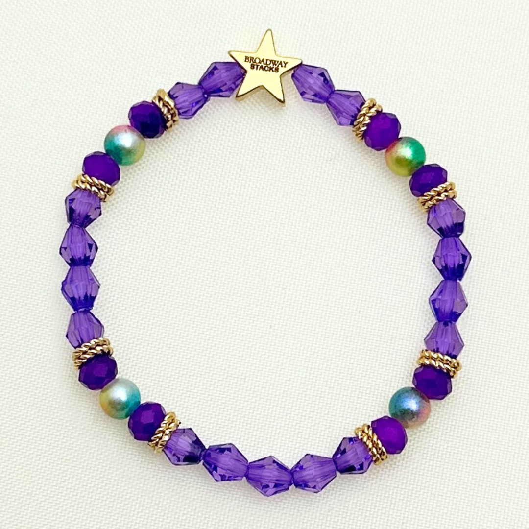 Broadway Stacks BroadwayCon X 2025 Broadway Lover bracelet. Purple, gold and iridescent colored beads.