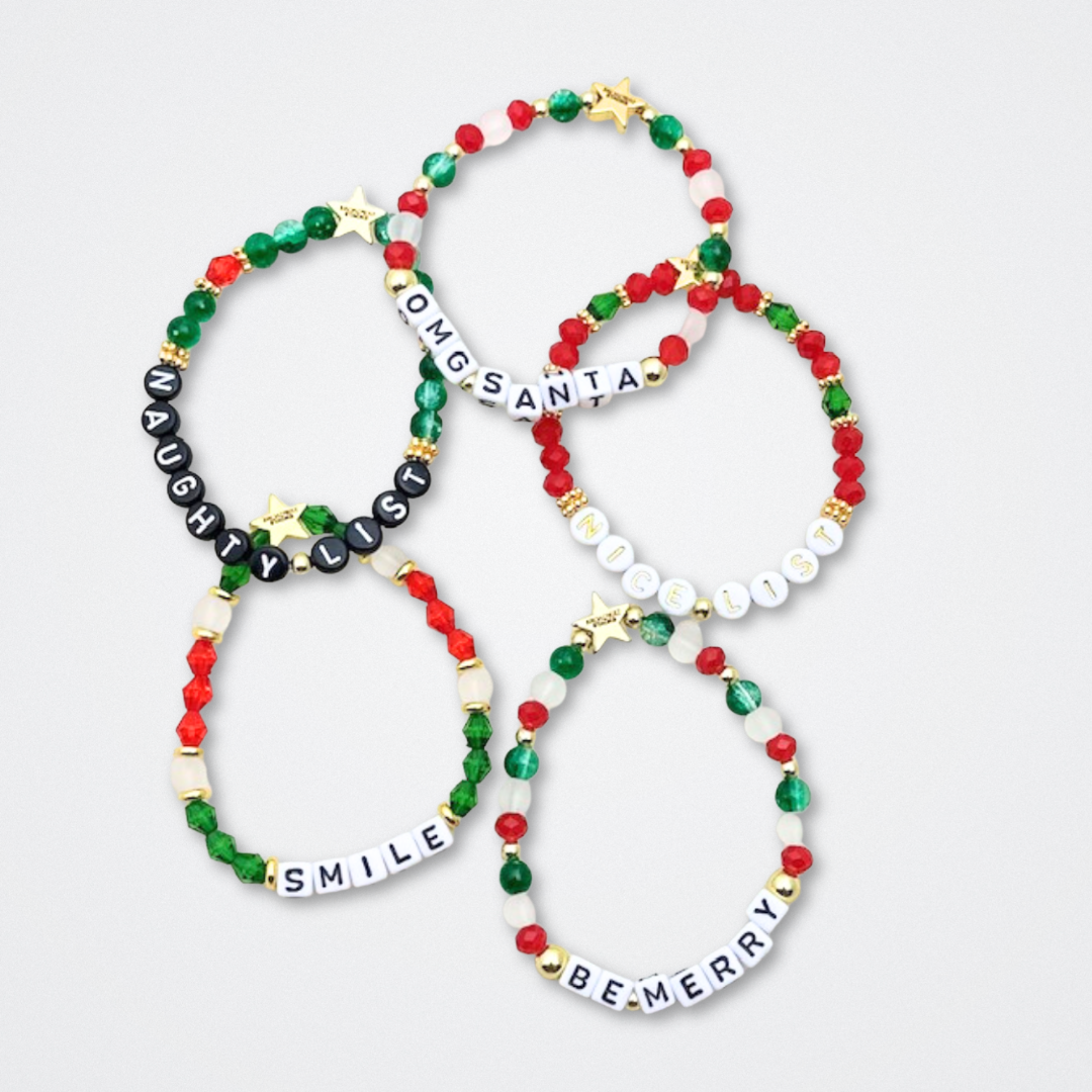 Broadway Stacks CHRISTMAS ELF Collection. Coordinating bead bracelets included in Stack. Red, green, white and gold colored beads. Letter beads that spell quotes. Gold star logo bead to remind you that you shine. Elf the Musical and Christmas holiday fans.
