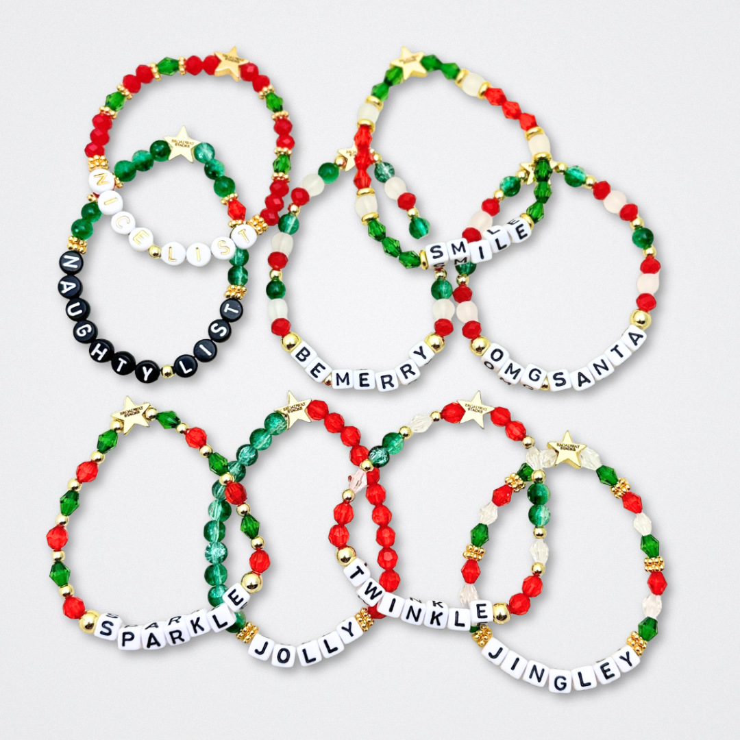 Broadway Stacks CHRISTMAS ELF Collection. Coordinating bead bracelets included in Stack. Red, green, white and gold colored beads. Letter beads that spell quotes. Gold star logo bead to remind you that you shine. Elf the Musical and Christmas holiday fans.