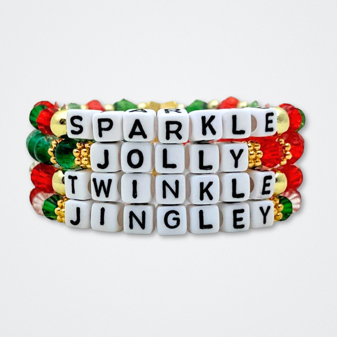 Broadway Stacks CHRISTMAS ELF Collection. Coordinating bead bracelets included in Stack. Red, green, white and gold colored beads. Letter beads that spell quotes. Gold star logo bead to remind you that you shine. Elf the Musical and Christmas holiday fans.