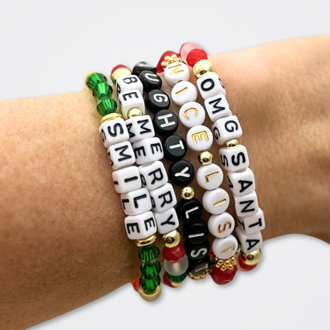 Broadway Stacks CHRISTMAS ELF Collection. Coordinating bead bracelets included in Stack. Red, green, white and gold colored beads. Letter beads that spell quotes. Gold star logo bead to remind you that you shine. Elf the Musical and Christmas holiday fans.