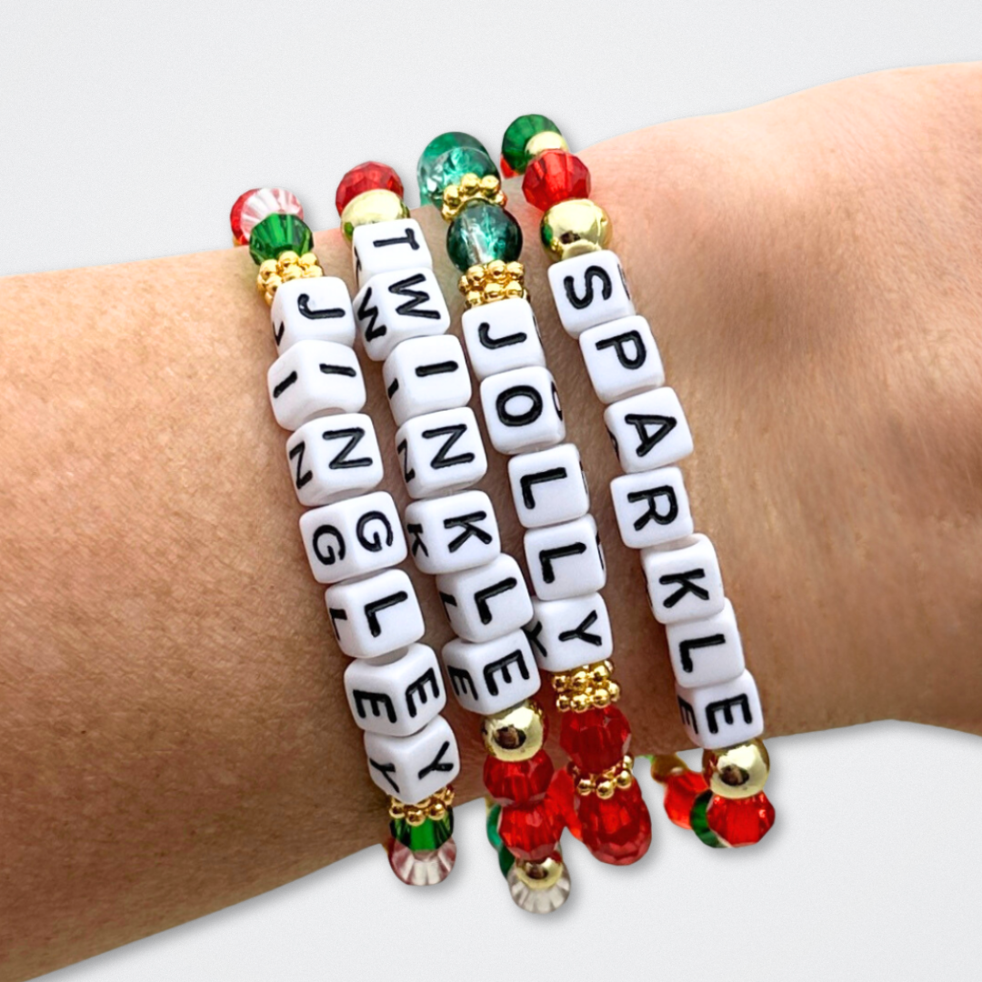 Broadway Stacks CHRISTMAS ELF Collection. Coordinating bead bracelets included in Stack. Red, green, white and gold colored beads. Letter beads that spell quotes. Gold star logo bead to remind you that you shine. Elf the Musical and Christmas holiday fans.