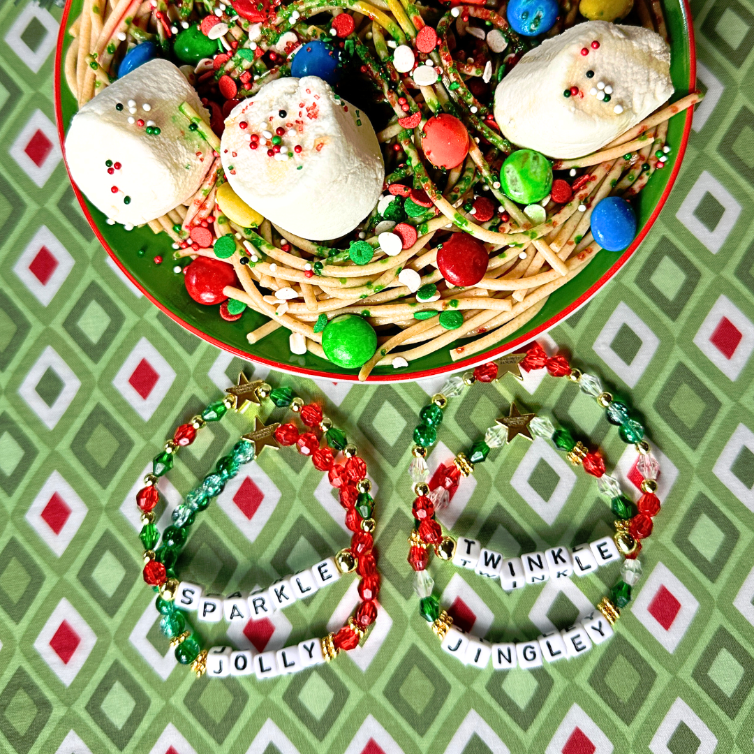 Broadway Stacks CHRISTMAS ELF Collection. Coordinating bead bracelets included in Stack. Red, green, white and gold colored beads. Letter beads that spell quotes. Gold star logo bead to remind you that you shine. Elf the Musical and Christmas holiday fans.