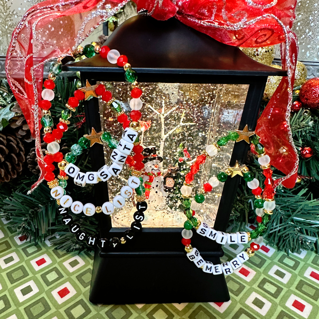 Broadway Stacks CHRISTMAS ELF Collection. Coordinating bead bracelets included in Stack. Red, green, white and gold colored beads. Letter beads that spell quotes. Gold star logo bead to remind you that you shine. Elf the Musical and Christmas holiday fans.