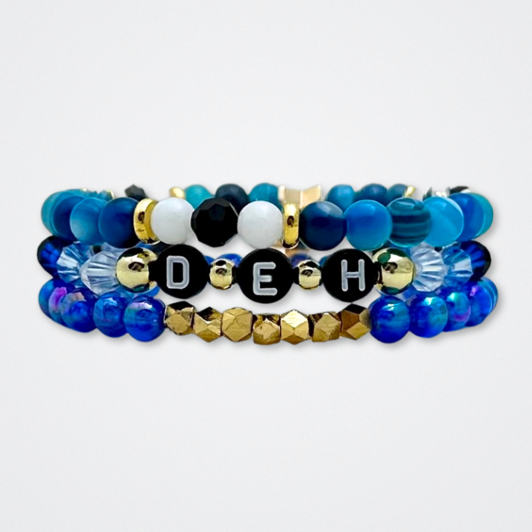 Broadway Stacks SKY collection. 3 stretch bracelets included in Stack. Blues, white, black and gold colored beads. Letter beads that spell quotes. Gold star logo bead to remind you that You Shine. Dear Evan Hansen DEH fans.