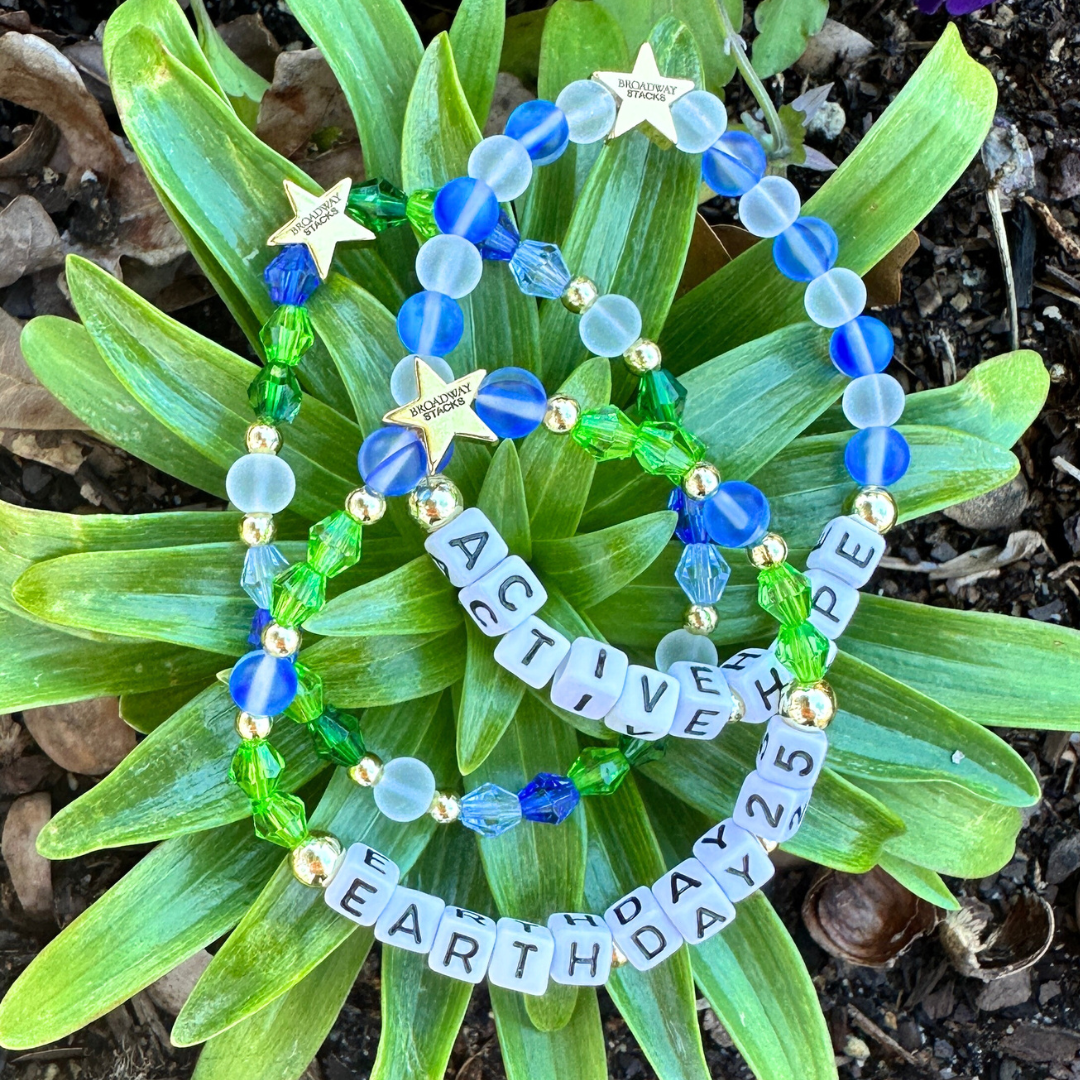 Earth Day 2025 Special Edition bracelet. Stack of 3 bracelets. Green, blue, white and gold beads. Letter beads that spell Earth Day 25 and Active Hope. Gold star logo bead to remind you that you shine.