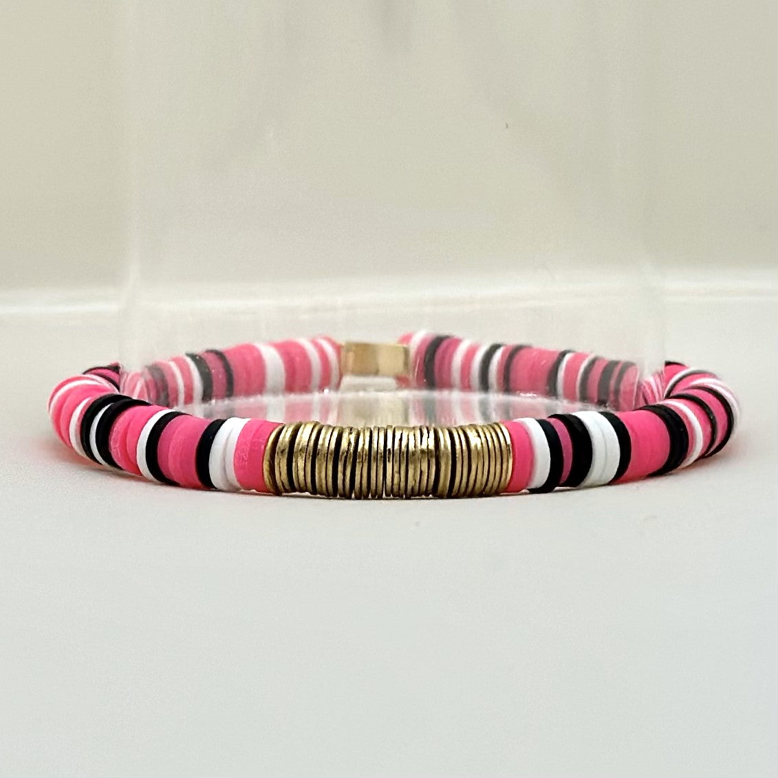 Broadway Stacks POTUS collection. 3 stretch bracelets included in Stack. Pinks, white, blue, golds and black colored beads. Letter beads that spell show quotes. Broadway Stacks gold star logo bead on back.