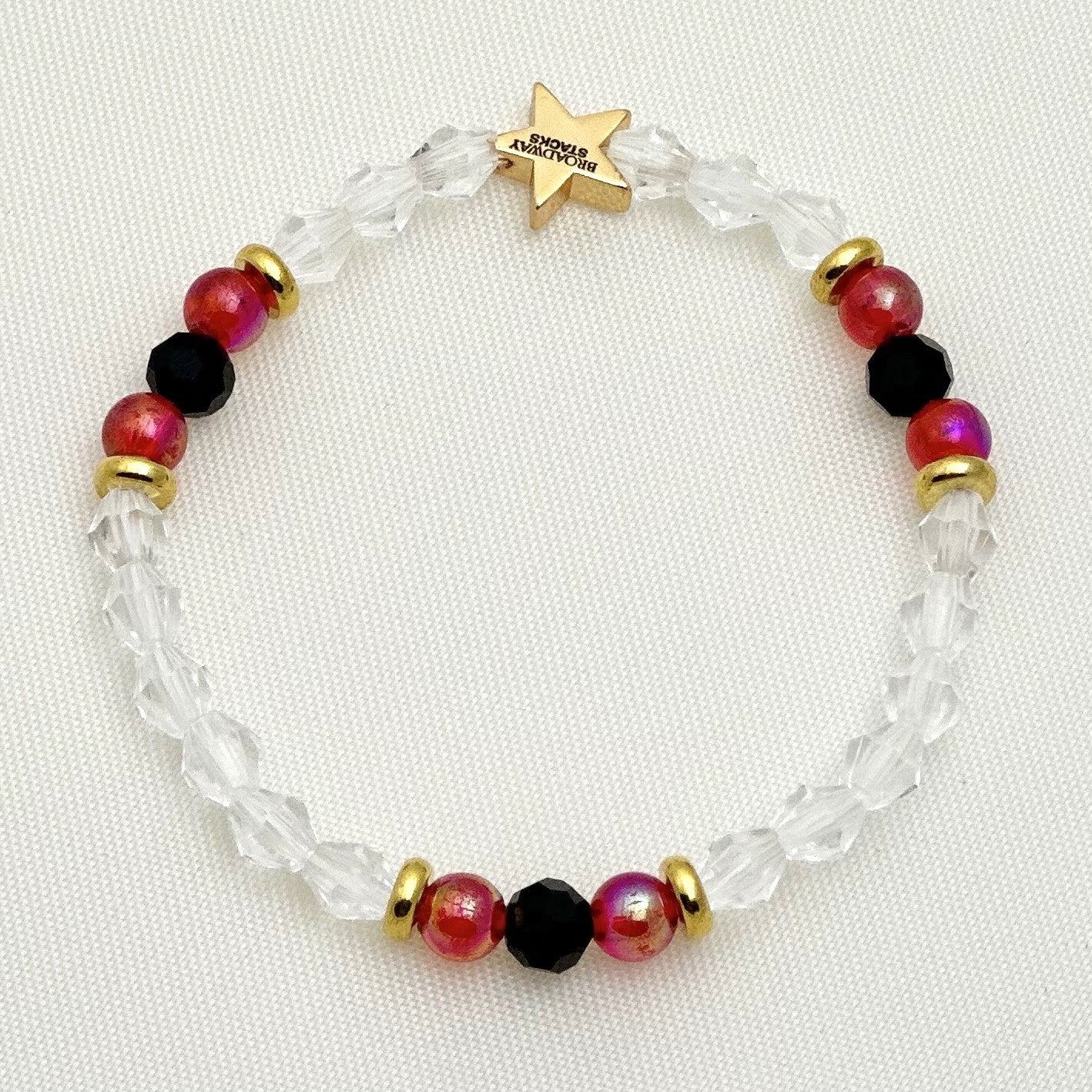 Broadway Stacks Phantom collection. 3 stretch bracelets included in Stack. Red, black, white and gold colored beads. Letter beads that spell Angel Of Music.