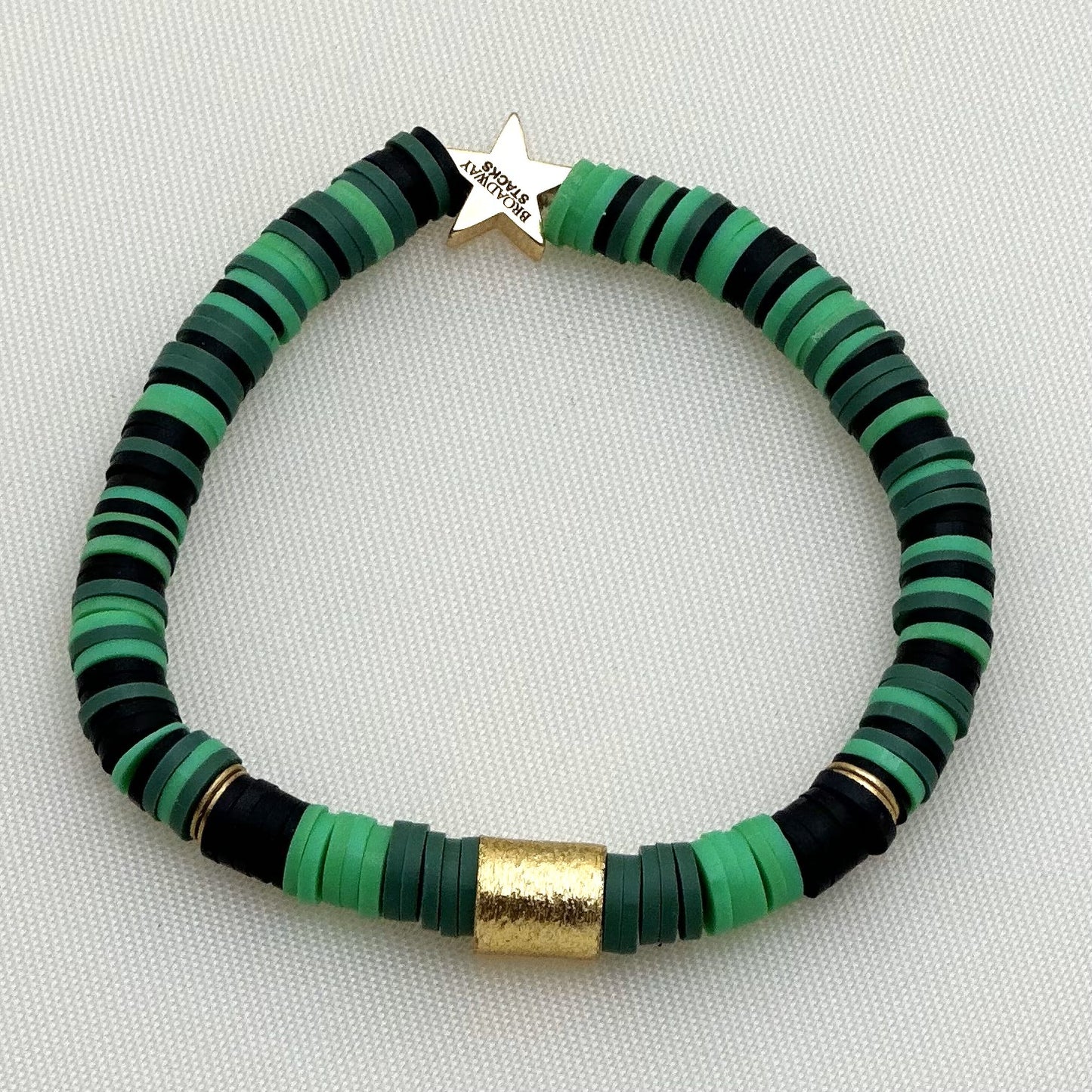 Broadway Stacks WITCH collection. 3 stretch bracelets included in Stack. Greens, white, pinks, gold and black colored beads. Letter beads that spell show quotes. Broadway Stacks gold star logo bead on back.