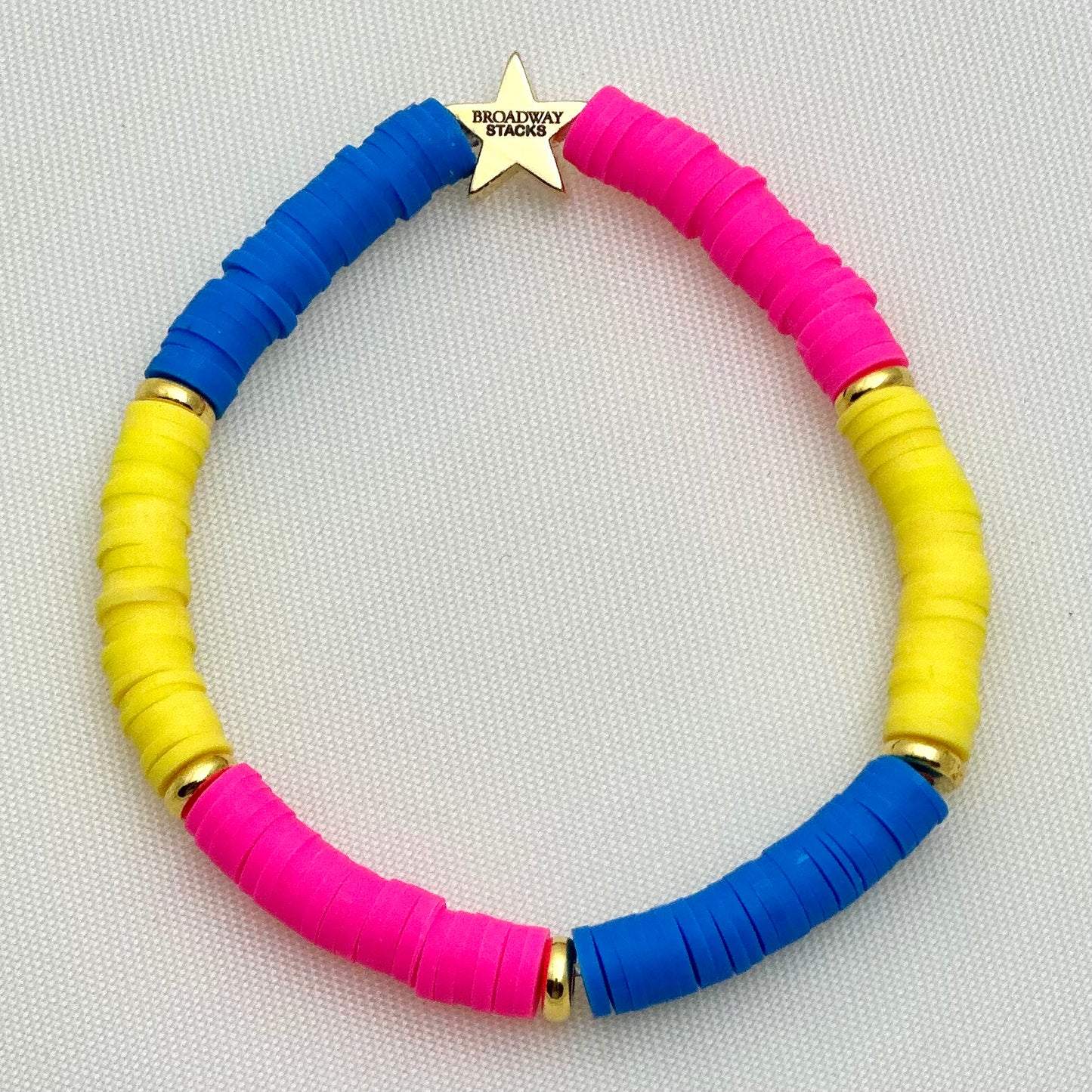 Broadway Stacks PRIDE collection. Avaliable in 8 designs. Red, orange, yellow, green, blue, purple, pink, white, grey, black and gold colored beads. Broadway Stacks gold star logo bead on back.