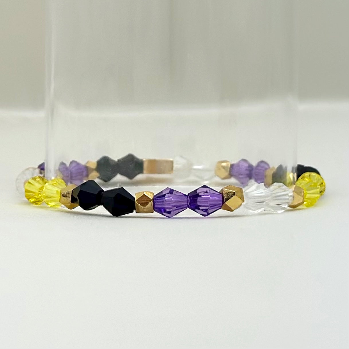 Broadway Stacks PRIDE collection. Avaliable in 8 designs. Red, orange, yellow, green, blue, purple, pink, white, grey, black and gold colored beads. Broadway Stacks gold star logo bead on back.