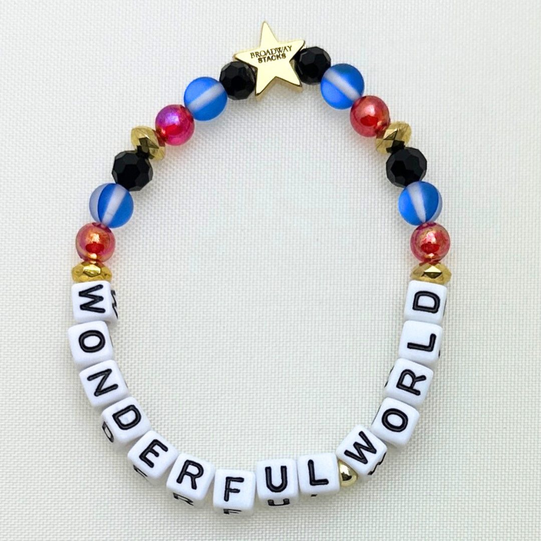 Broadway Stacks JAZZY Collection. 5 stretch bracelets included in Stack. Red, blue, black and gold colored beads. Letter beads that spell quotes. Gold star logo bead to remind you that you shine.