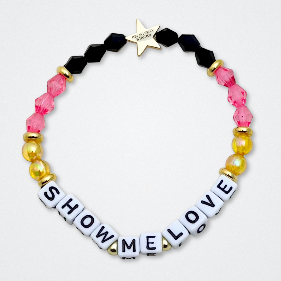 Broadway Stacks De Bois Band collection. 3 stretch bracelets included in Stack. Pinks, golds and black colored beads. Letter beads that spell quotes. Broadway Stacks gold star logo bead to remind you that you shine. & Juliet fans.