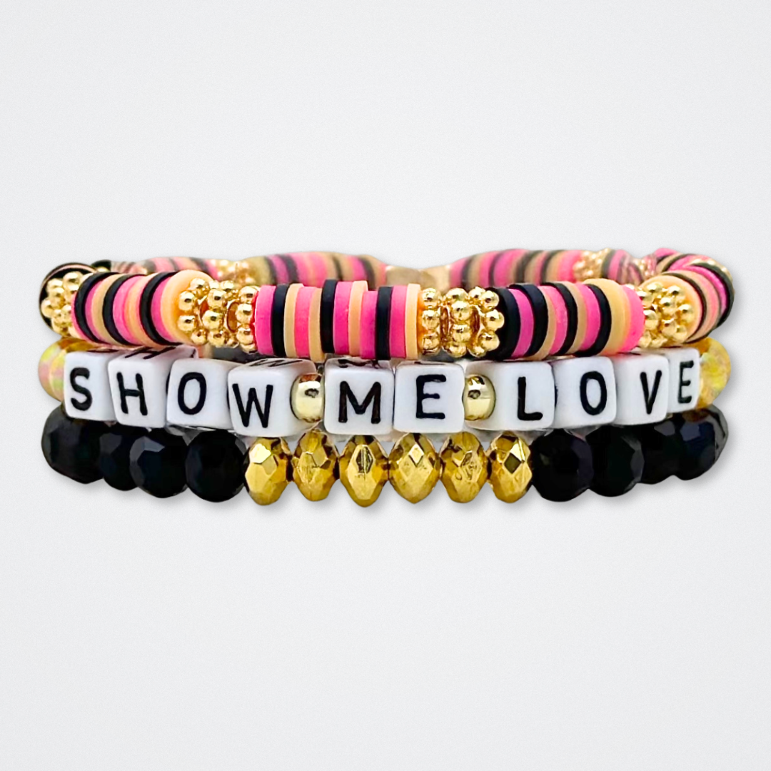 Broadway Stacks De Bois Band collection. 3 stretch bracelets included in Stack. Pinks, golds and black colored beads. Letter beads that spell quotes. Broadway Stacks gold star logo bead to remind you that you shine. & Juliet fans.
