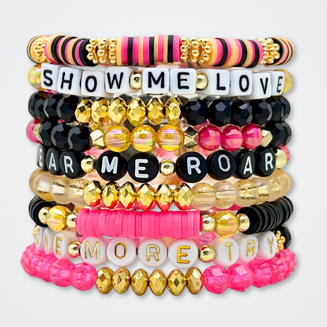 Broadway Stacks De Bois Band collection. 3 stretch bracelets included in Stack. Pinks, golds and black colored beads. Letter beads that spell quotes. Broadway Stacks gold star logo bead to remind you that you shine. & Juliet fans.
