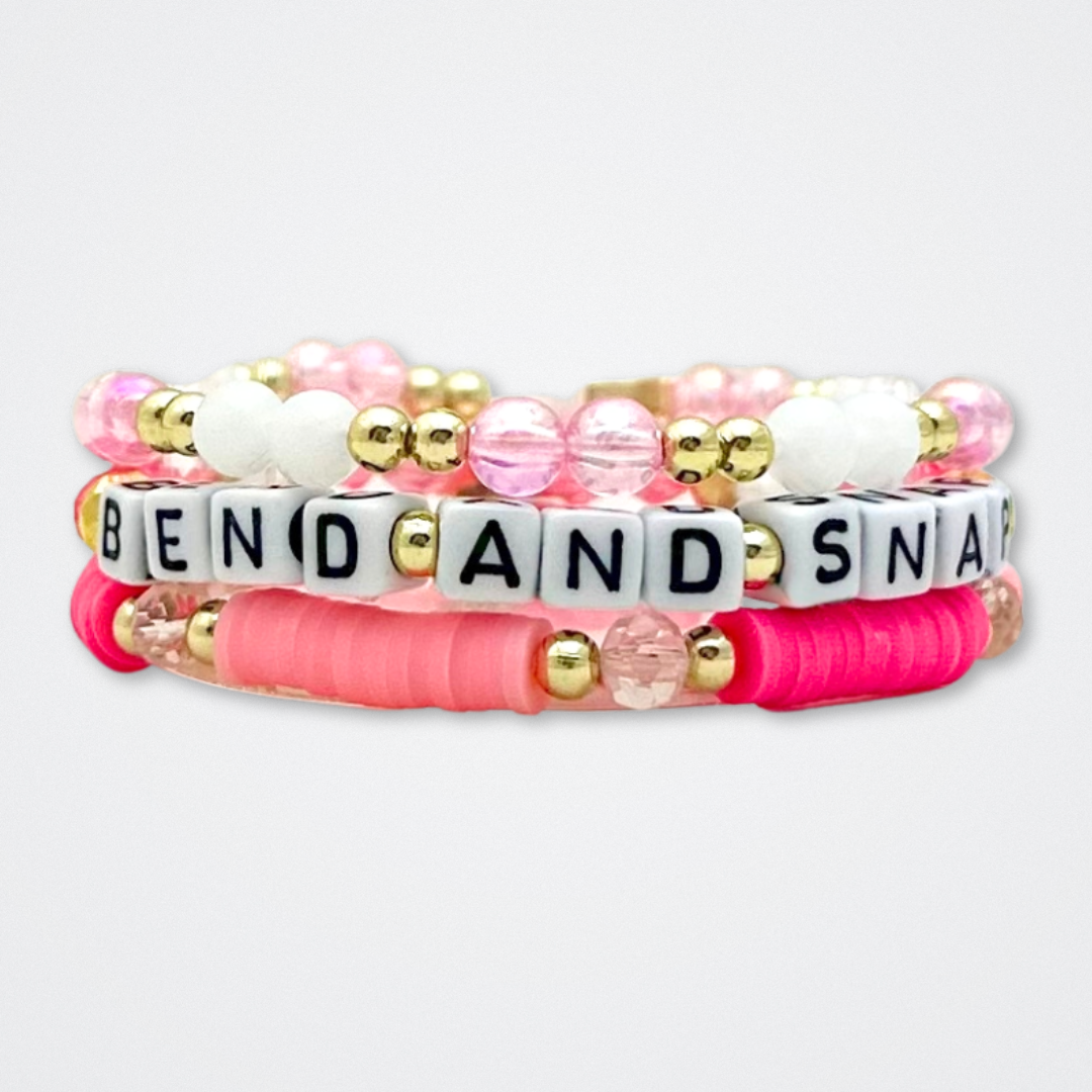 Broadway Stacks KEEP IT POSITIVE Collection. 9 stretch bracelets included in Stack. Pinks, white and gold colored beads. Letter beads that spell quotes. Gold star logo bead to remind you that you shine. Legally Blonde fans.