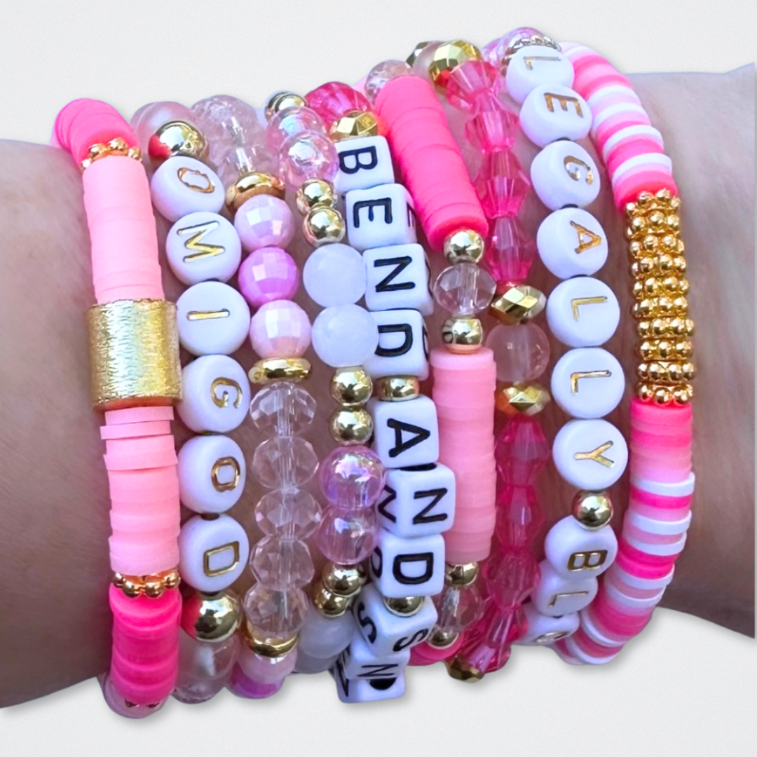 Broadway Stacks KEEP IT POSITIVE Collection. 9 stretch bracelets included in Stack. Pinks, white and gold colored beads. Letter beads that spell quotes. Gold star logo bead to remind you that you shine. Legally Blonde fans.