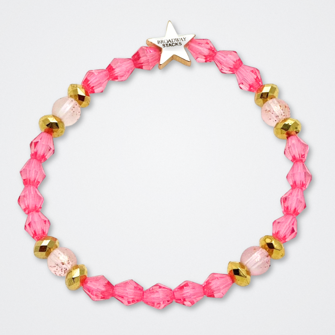 Broadway Stacks KEEP IT POSITIVE Collection. 9 stretch bracelets included in Stack. Pinks, white and gold colored beads. Letter beads that spell quotes. Gold star logo bead to remind you that you shine. Legally Blonde fans.