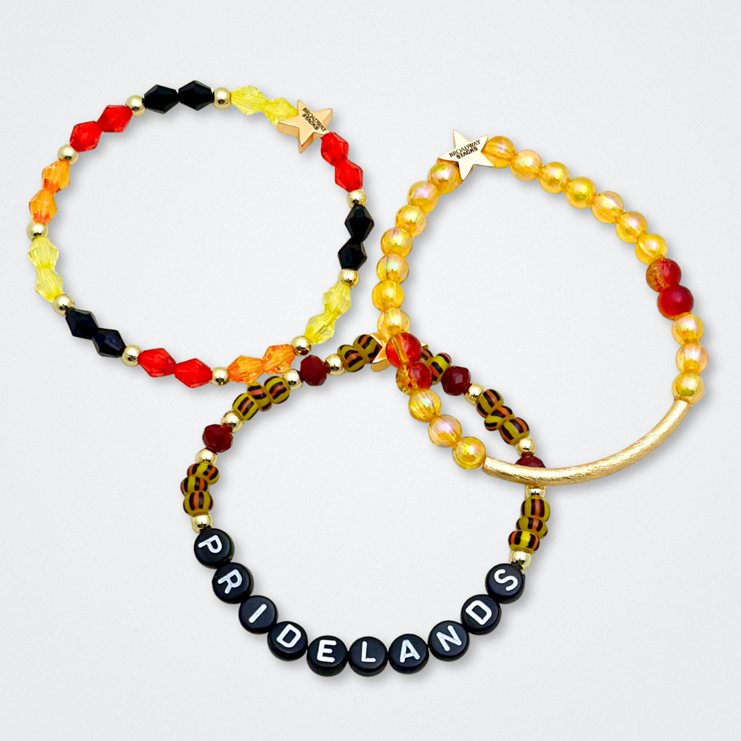 Broadway Stacks SAFARI collection. 3 stretch bracelets included in Stack. Dark reds, yellow, orange, white, black and gold colored beads. Animal print beads as well. Letter beads that spell quotes, Gold star logo bead to remind you that you shine.