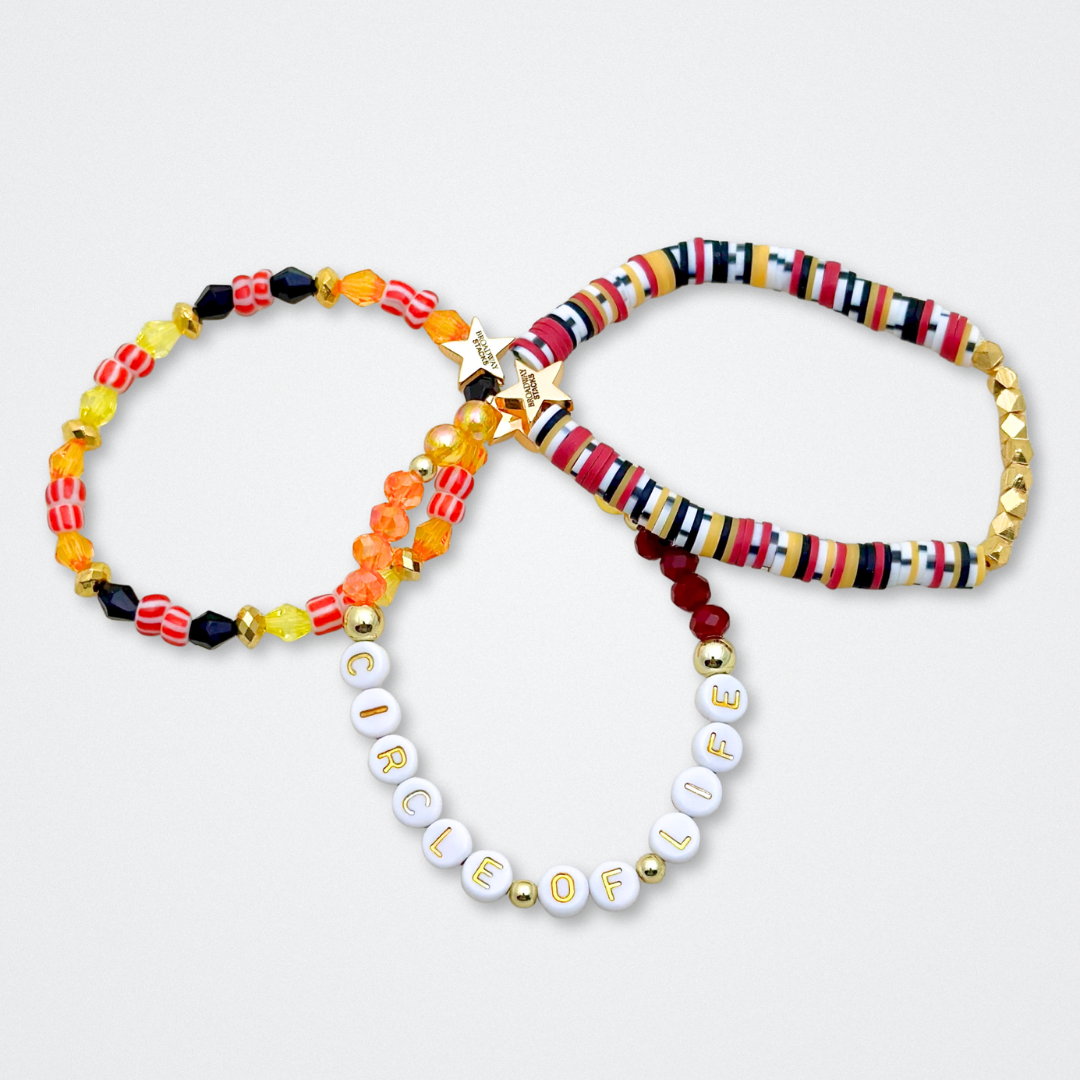 Broadway Stacks SAFARI collection. 3 stretch bracelets included in Stack. Dark reds, yellow, orange, white, black and gold colored beads. Animal print beads as well. Letter beads that spell quotes, Gold star logo bead to remind you that you shine.