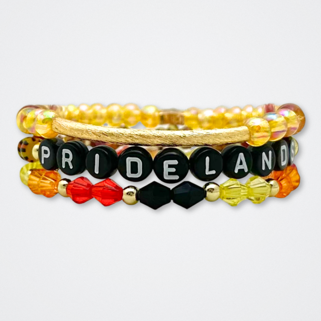 Broadway Stacks SAFARI collection. 3 stretch bracelets included in Stack. Dark reds, yellow, orange, white, black and gold colored beads. Animal print beads as well. Letter beads that spell quotes, Gold star logo bead to remind you that you shine.