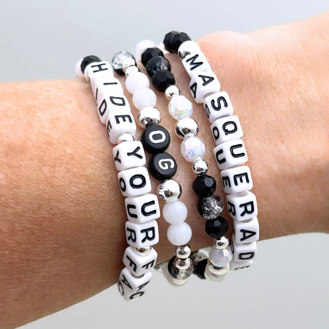 Broadway Stacks MASQUERADE Collection. 4 stretch bracelets included in Stack. Black, white and silver colored beads. Letter beads that spell quotes. Gold star logo bead to remind you that you shine. Phantom of the Opera and Masquerade NYC fans.