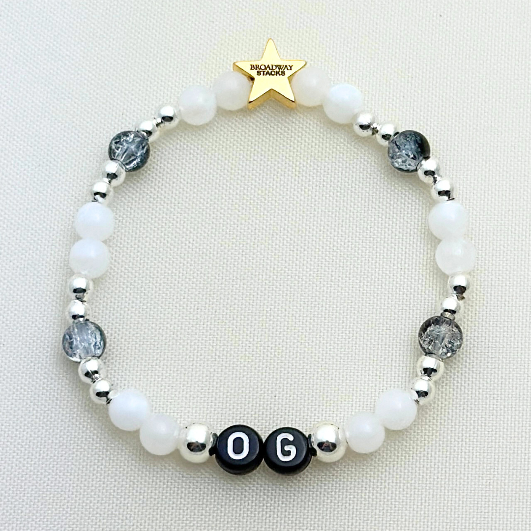 Broadway Stacks MASQUERADE Collection. 4 stretch bracelets included in Stack. Black, white and silver colored beads. Letter beads that spell quotes. Gold star logo bead to remind you that you shine. Phantom of the Opera and Masquerade NYC fans.