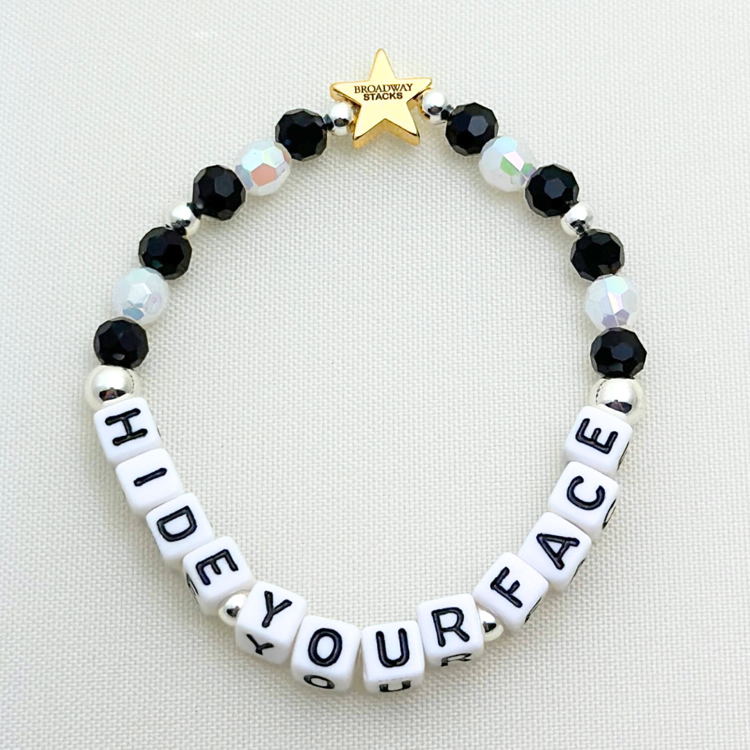 Broadway Stacks MASQUERADE Collection. 4 stretch bracelets included in Stack. Black, white and silver colored beads. Letter beads that spell quotes. Gold star logo bead to remind you that you shine. Phantom of the Opera and Masquerade NYC fans.