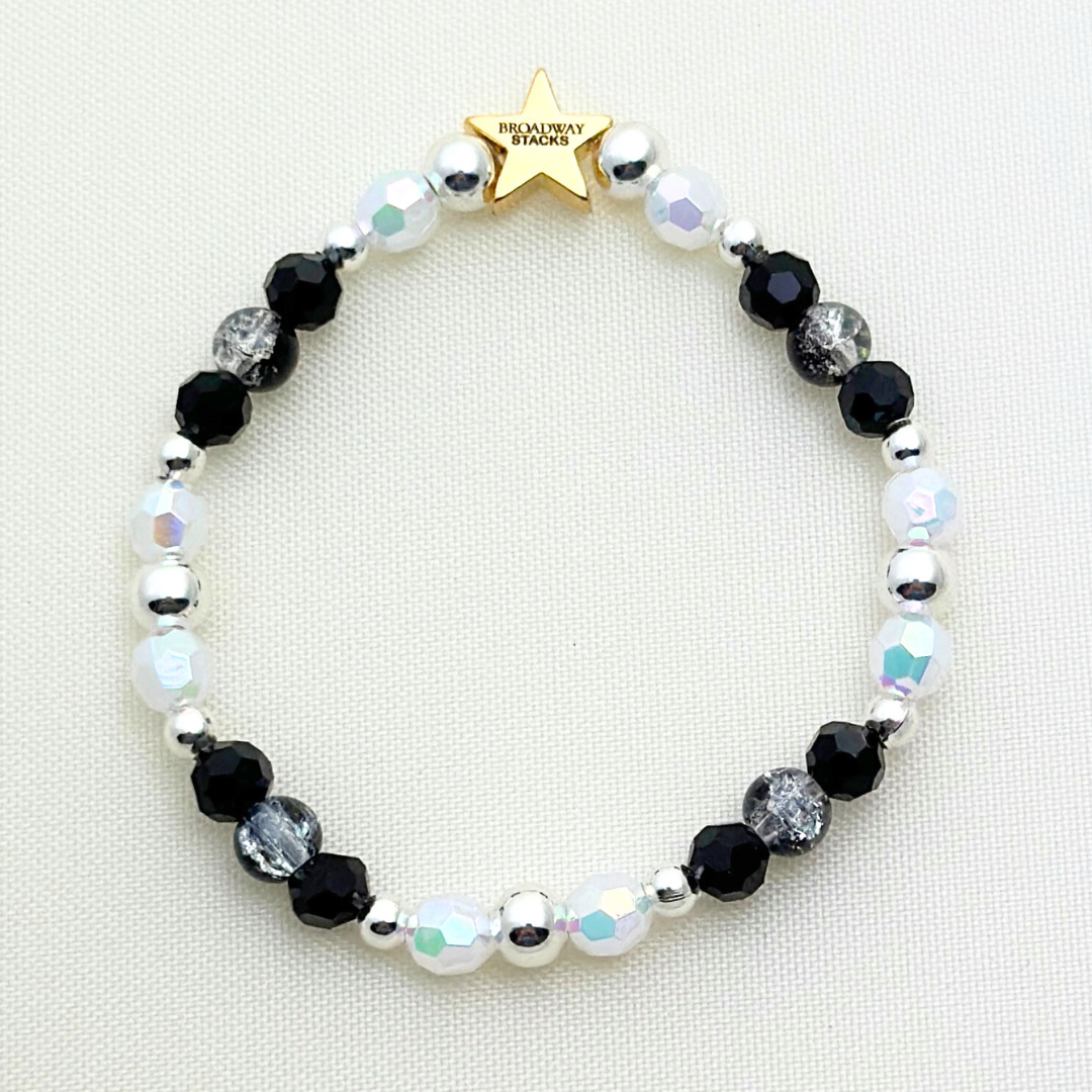 Broadway Stacks MASQUERADE Collection. 4 stretch bracelets included in Stack. Black, white and silver colored beads. Letter beads that spell quotes. Gold star logo bead to remind you that you shine. Phantom of the Opera and Masquerade NYC fans.