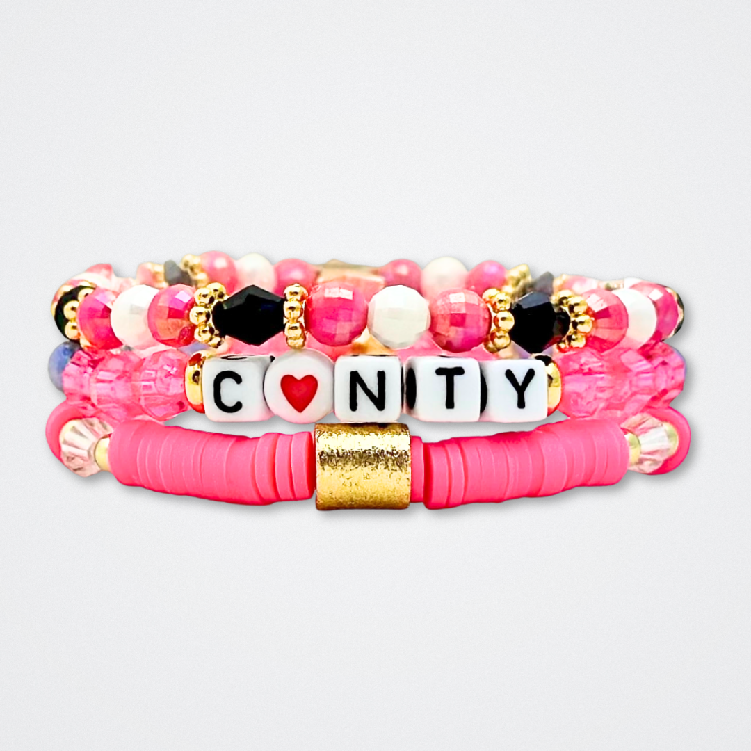 Broadway Stacks POTUS collection. 3 stretch bracelets included in Stack. Pinks, white, blue, golds and black colored beads. Letter beads that spell show quotes. Broadway Stacks gold star logo bead to remind you that You Shine. POTUS play fans.