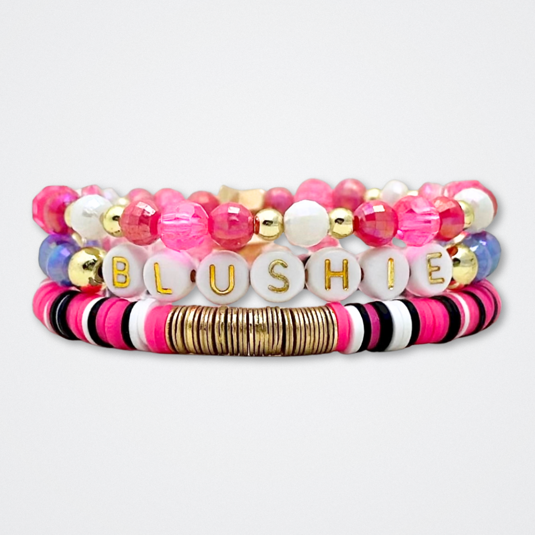 Broadway Stacks POTUS collection. 3 stretch bracelets included in Stack. Pinks, white, blue, golds and black colored beads. Letter beads that spell show quotes. Broadway Stacks gold star logo bead to remind you that You Shine. POTUS play fans.