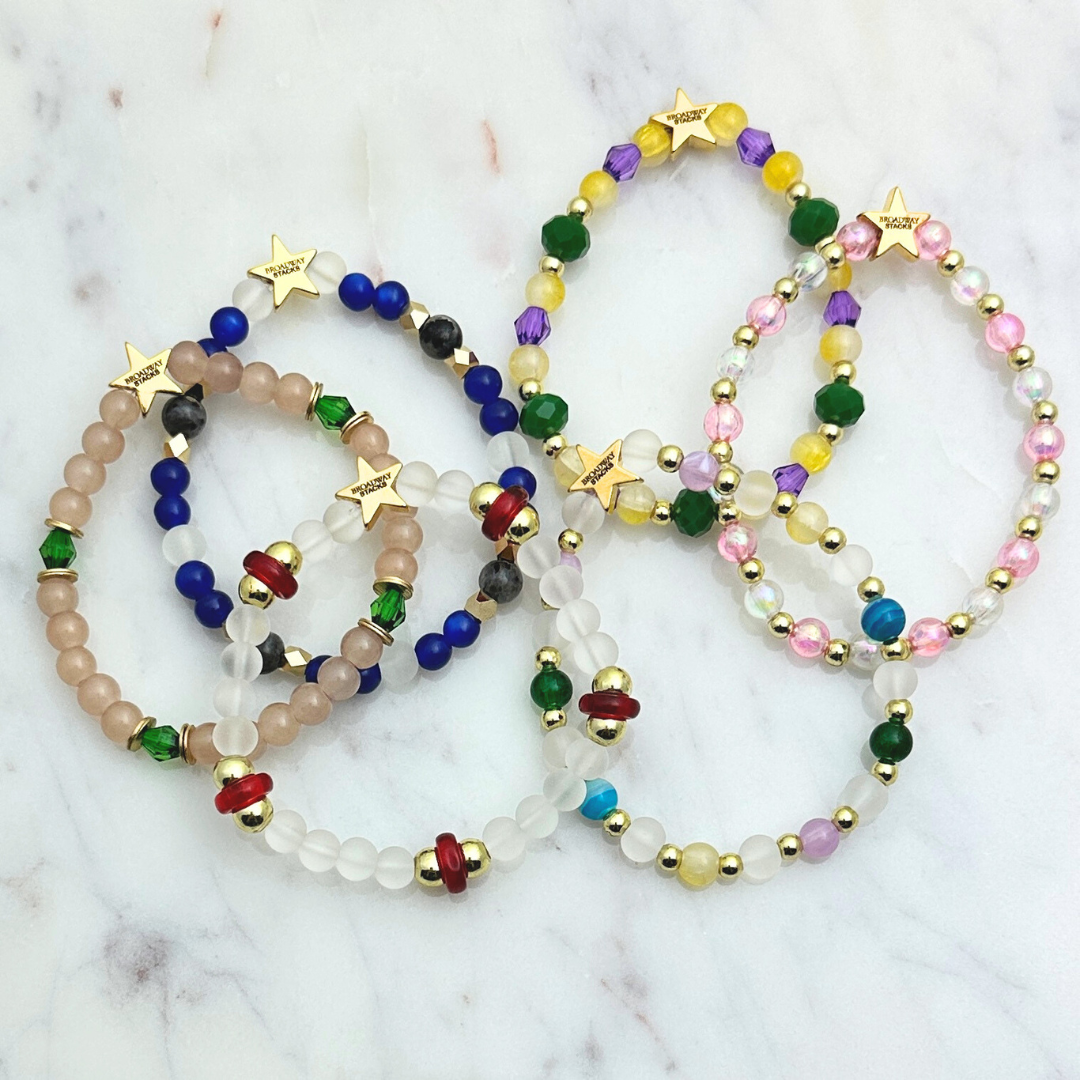 Broadway Stacks STAY GOLD collection. Stretch bracelets included in Stack. Inspired by characters from The Outsiders. Broadway Stacks gold star logo bead on back.