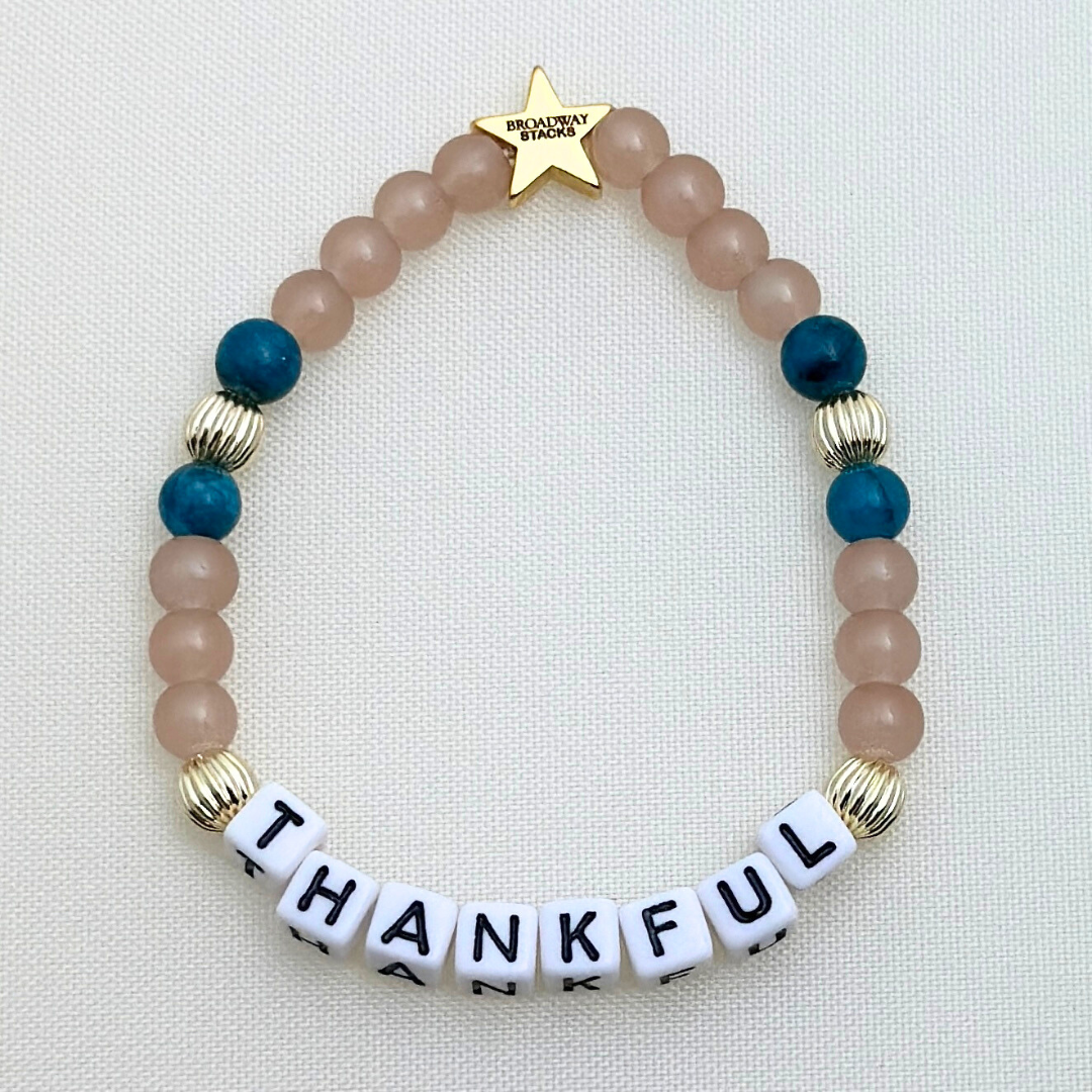 Broadway Stacks SAILOR Collection. 5 stretch bracelets included in Stack. Teal, green, blue and gold colored beads. Letter beads that spell quotes. Gold star logo bead to remind you that you shine.