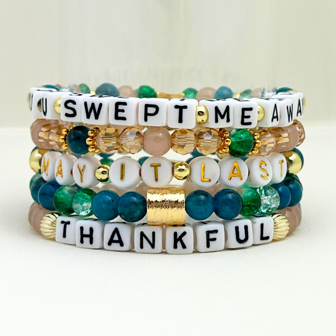 Broadway Stacks SAILOR Collection. 5 stretch bracelets included in Stack. Teal, green, blue and gold colored beads. Letter beads that spell quotes. Gold star logo bead to remind you that you shine.