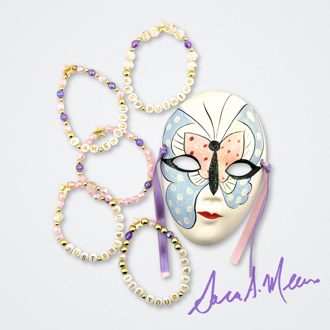 Broadway Stacks Special Edition Sara Mearns STAGE Bracelet Collection. 5 stretch bracelets included in Stack. Purple, pink, clear, white, glitter and gold colored beads. Letter beads that spell quotes. Gold star logo bead to remind you that you shine. Sara Mearns NYCB Principal Dancer and Ballet fans.