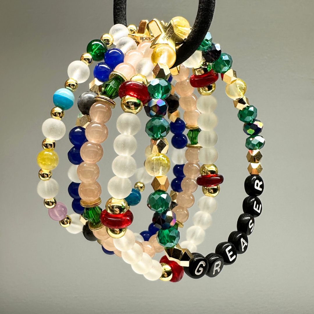 Broadway Stacks STAY GOLD collection. Stretch bracelets included in Stack. Inspired by characters from The Outsiders. Broadway Stacks gold star logo bead on back.
