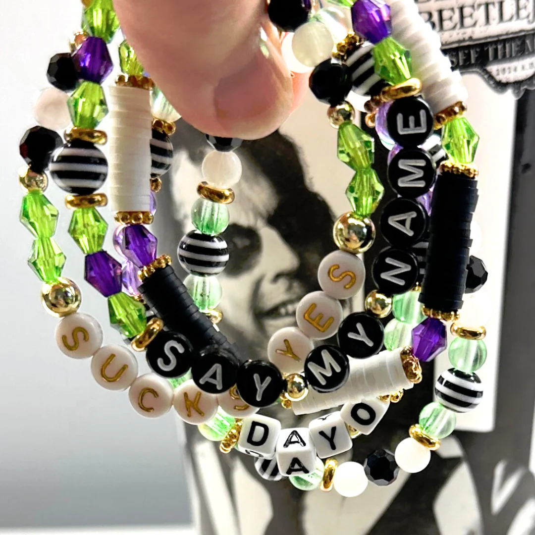 Broadway Stacks NETHERWORLD Collection. 5 stretch bracelets included in Stack. Green, black, purple, striped and gold colored beads. Letter beads that spell quotes. Gold star logo bead to remind you that you shine. Beetlejuice fans.