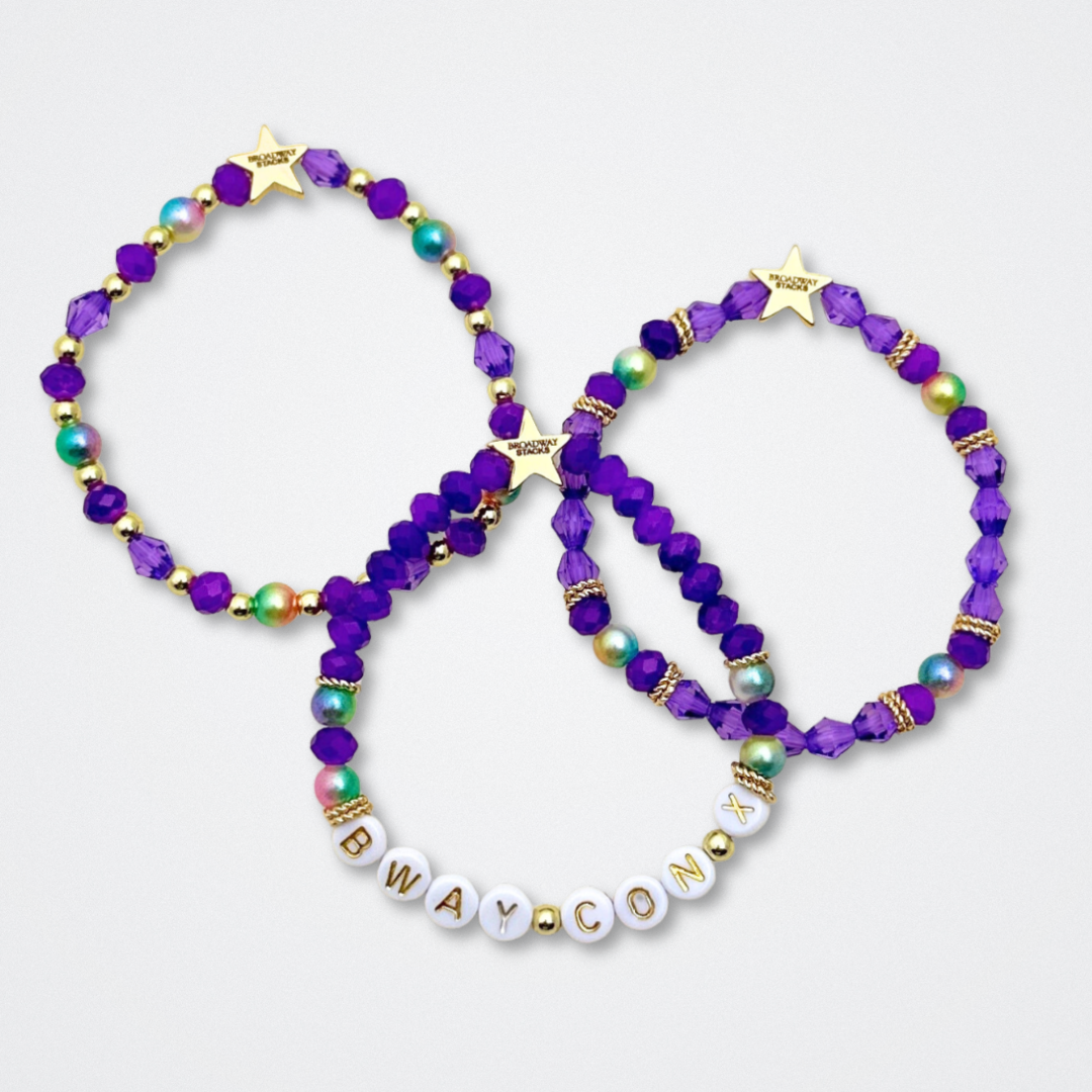 Broadway Stacks BroadwayCon X 2025 Special Edition bracelet. Stack of 3 bracelets. Purple, gold and iridescent colored beads. Letter beads that spell Bway Con X.