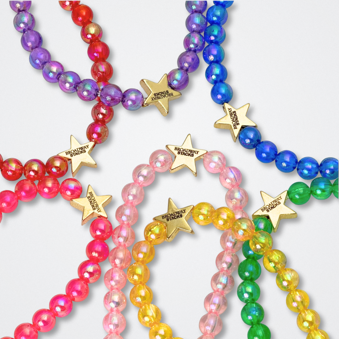 You create your own with CUSTOM text. Broadway Stacks rainbow colors elastic stretch bracelets with gold color accents. Gold star logo bead to remind you that You SHine. Available in red pink orange yellow green blue purple white black and mulit-color.