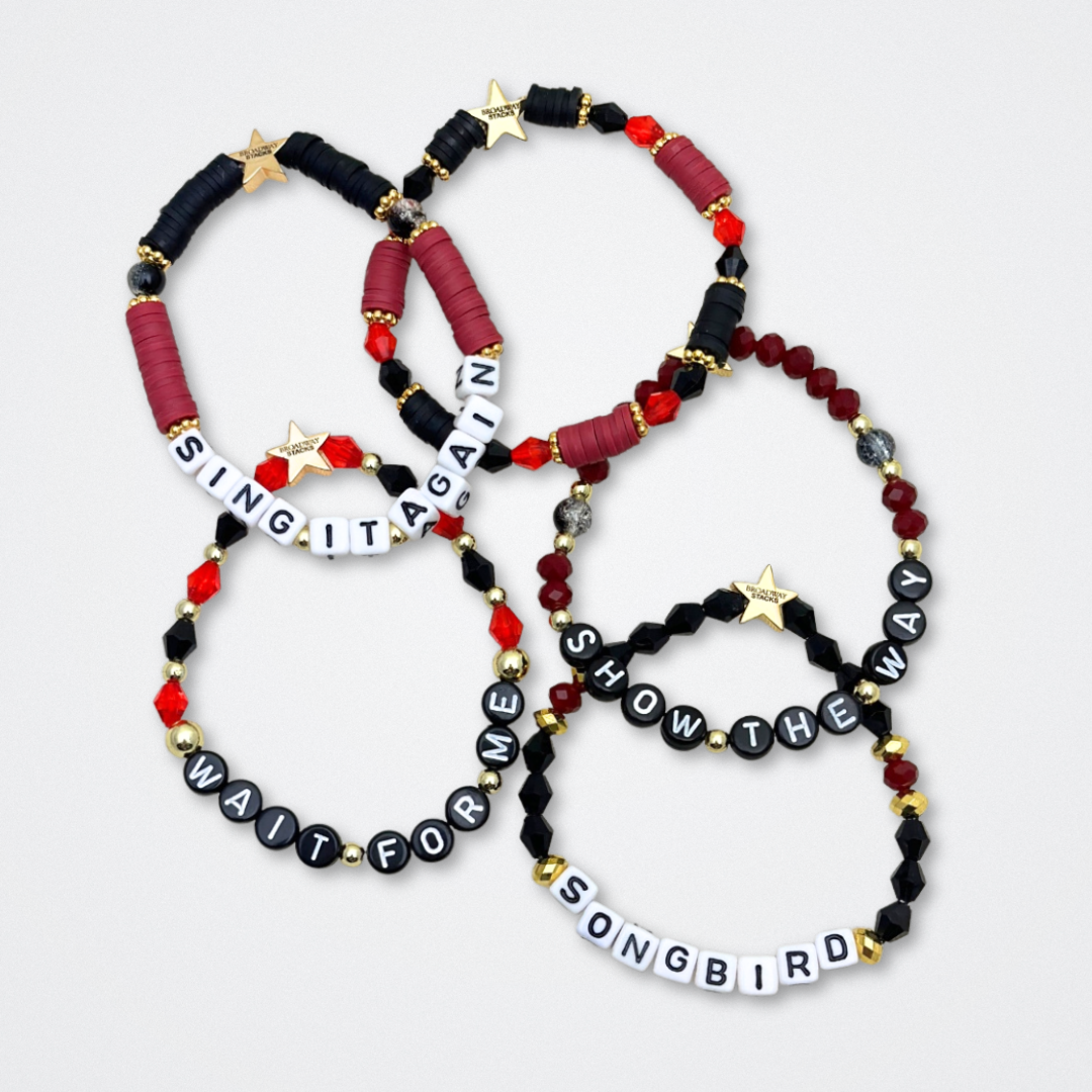 Broadway Stacks UNDERWORLD collection. 5 stretch bracelets included in Stack. Red, garnet, black and gold colored beads. Letter beads that spell quotes. Gold star logo bead to remind you that you shine. Hadestown fans.