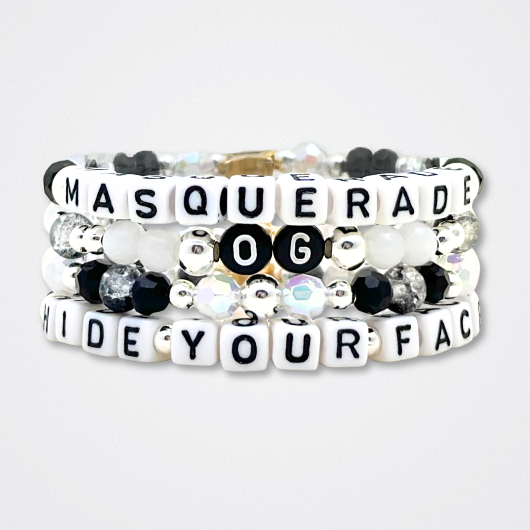 Broadway Stacks MASQUERADE Collection. 4 stretch bracelets included in Stack. Black, white and silver colored beads. Letter beads that spell quotes. Gold star logo bead to remind you that you shine. Phantom of the Opera and Masquerade NYC fans.