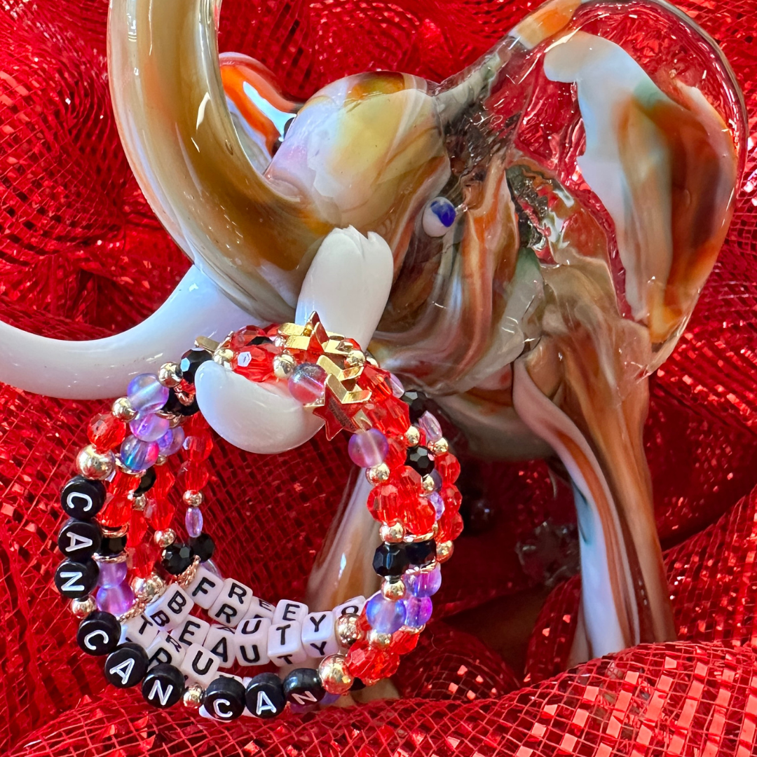Broadway Stacks RED LIGHT Collection. 5 stretch bracelets included in Stack. Red, purple, black and gold colored beads. Letter beads that spell quotes. Gold star logo bead to remind you that You Shine. Moulin Rouge fans.