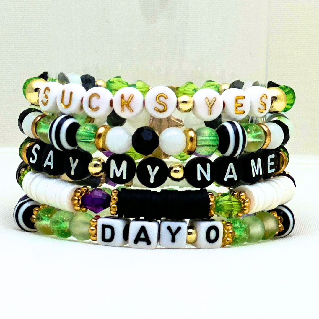 Broadway Stacks NETHERWORLD Collection. 5 stretch bracelets included in Stack. Green, black, purple, striped and gold colored beads. Letter beads that spell quotes. Gold star logo bead to remind you that you shine. Beetlejuice fans.