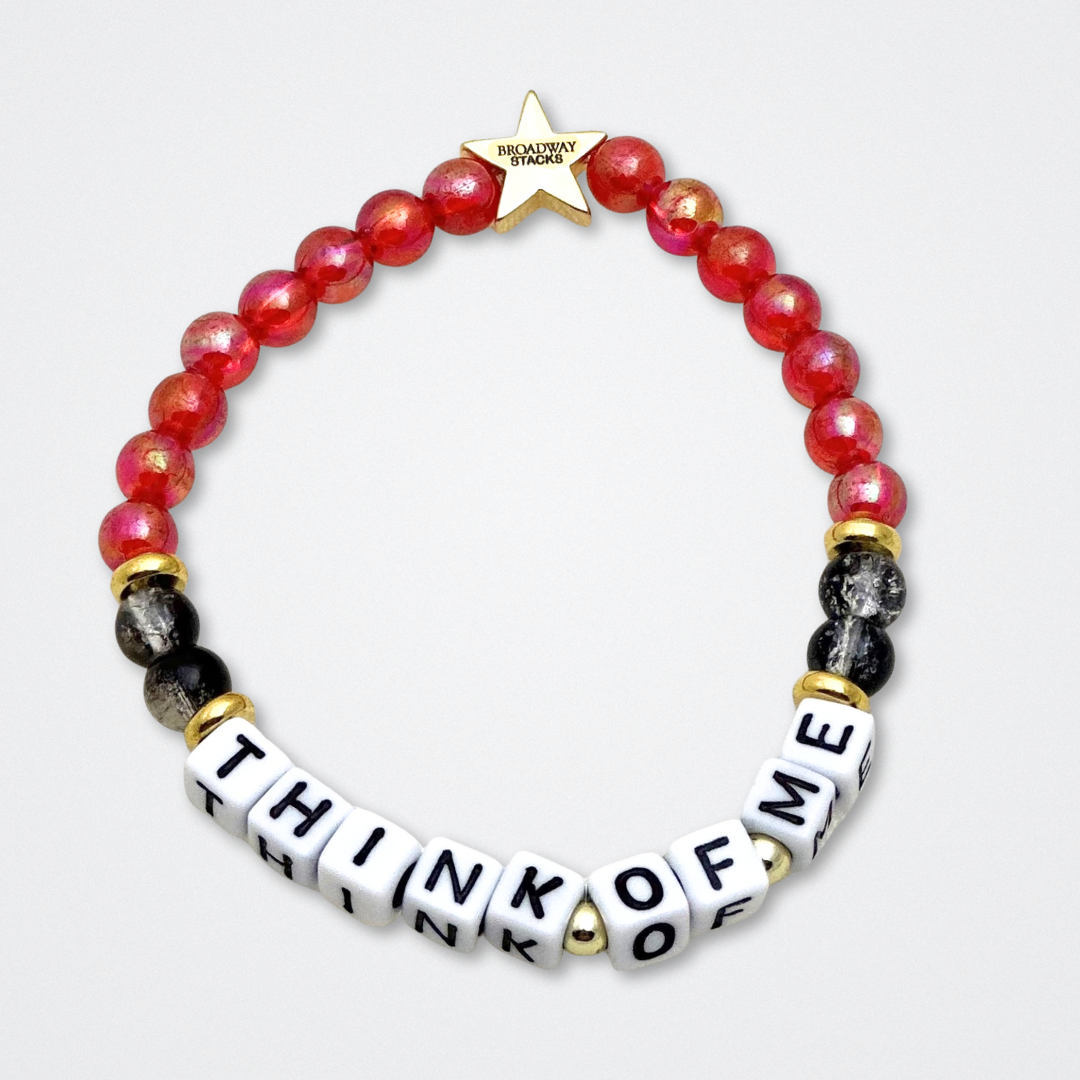 Broadway Stacks MASK collection. Bead bracelets included in Stack. Red, black, white and gold colored beads. Letter beads that spell quotes. Team Phantom, Team Christine, Team Raoul. Gold star logo bead to remind you that You Shine. Phantom of the Opera and Masquerade fans.