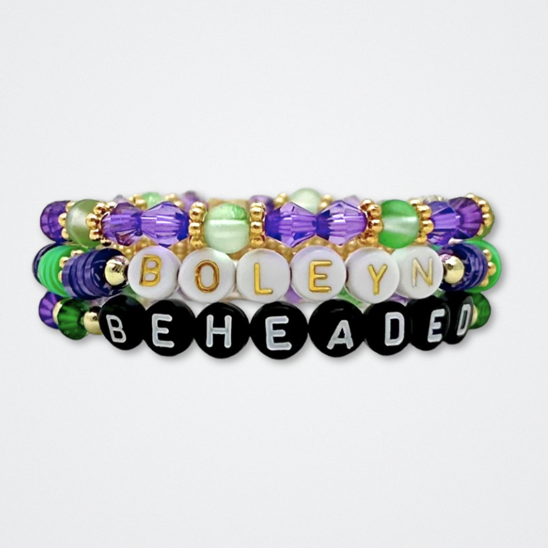 Broadway Stacks QUEEN collection. Stretch bracelets included in Stack. Gold, yellow, green, white, red, pink and blue colored beads. Letter beads that spell each queen. Also Herstory collection. Broadway Stacks gold star logo bead to remind you that You Shine. SIX the Musical fans.