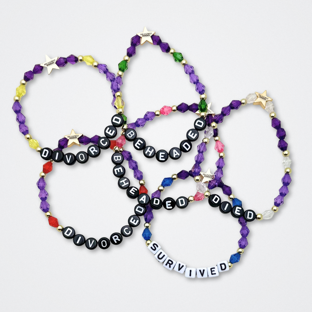 Broadway Stacks QUEEN collection. Stretch bracelets included in Stack. Gold, yellow, green, white, red, pink and blue colored beads. Letter beads that spell each queen. Also Herstory collection. Broadway Stacks gold star logo bead to remind you that You Shine. SIX the Musical fans.