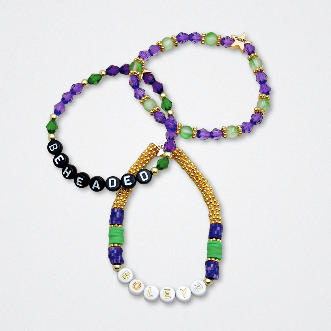Broadway Stacks QUEEN collection. Stretch bracelets included in Stack. Gold, yellow, green, white, red, pink and blue colored beads. Letter beads that spell each queen. Also Herstory collection. Broadway Stacks gold star logo bead to remind you that You Shine. SIX the Musical fans.
