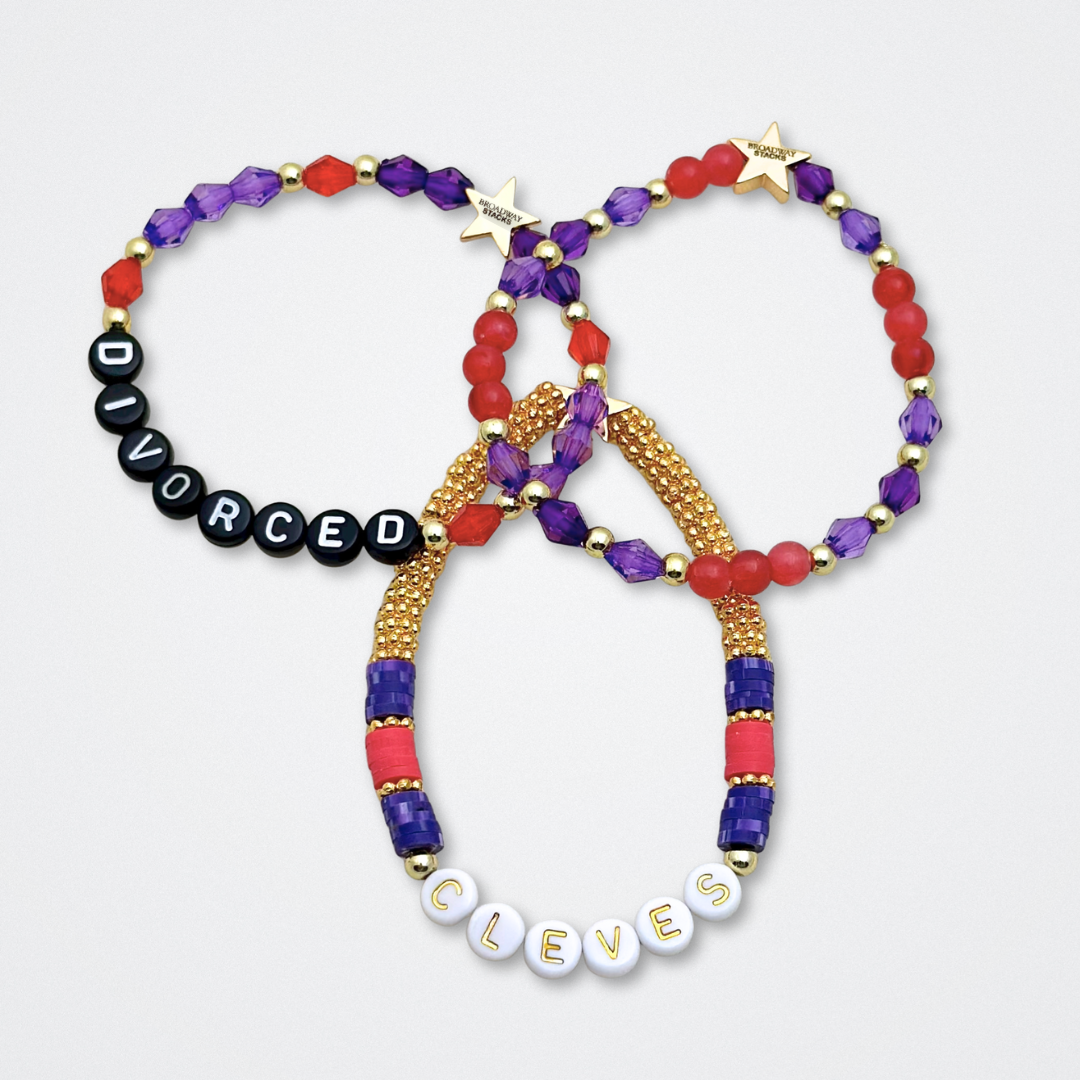 Broadway Stacks QUEEN collection. Stretch bracelets included in Stack. Gold, yellow, green, white, red, pink and blue colored beads. Letter beads that spell each queen. Also Herstory collection. Broadway Stacks gold star logo bead to remind you that You Shine. SIX the Musical fans.